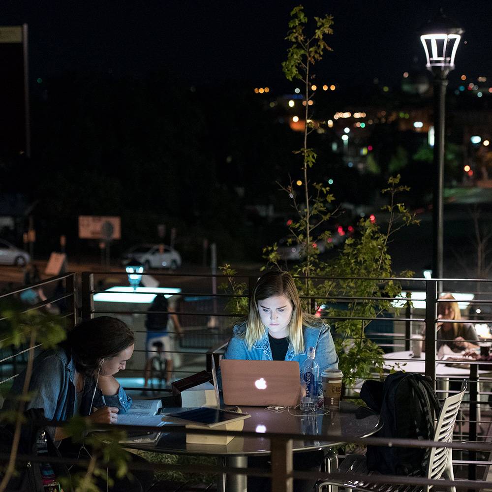 Students studying outdoors at night