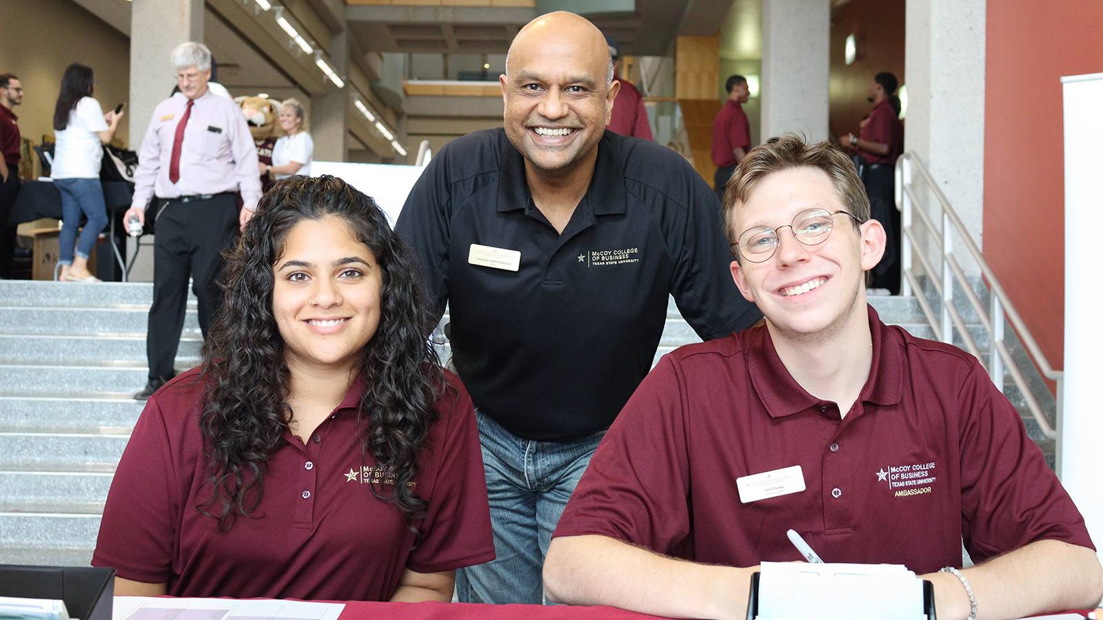 Two McCoy College Ambassadors at the check-in table for the Welcome Celebration with Dean Ramchander