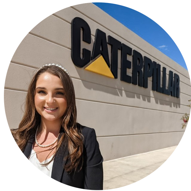 Alyssa Sjolander in front of Caterpillar sign