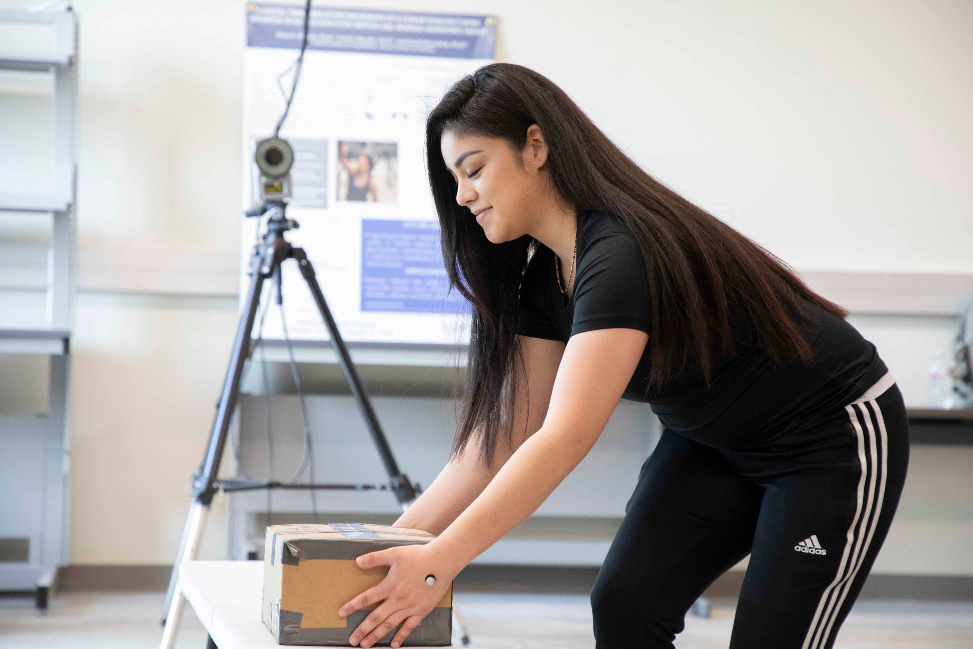 Woman setting up equipment to film