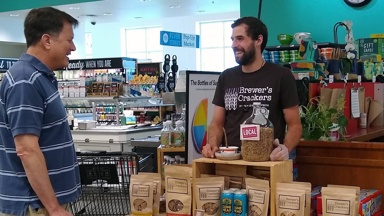 Person at a grocery store conducting a product demonstration
