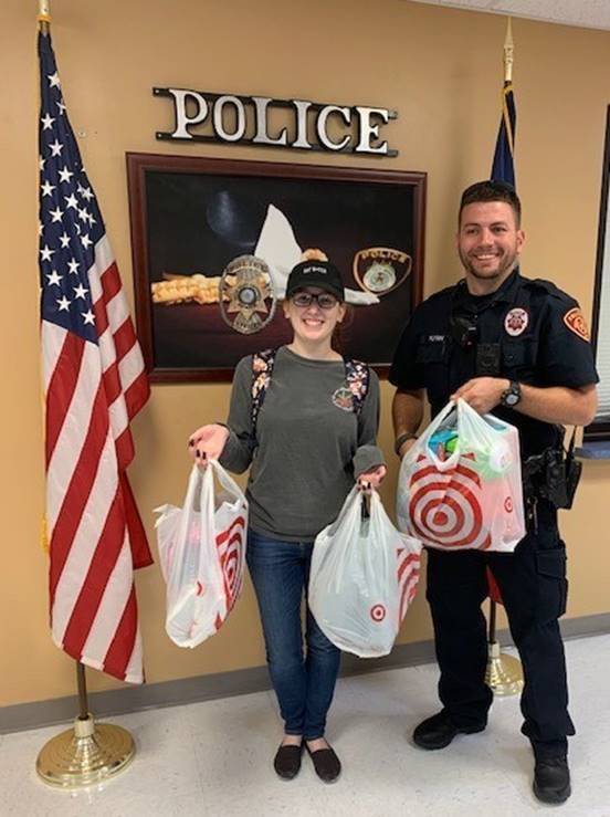 student and police officer with gifts