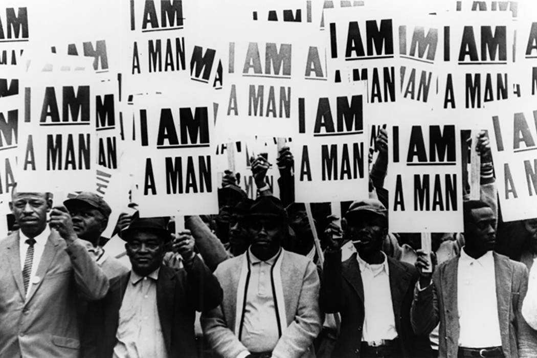 men holding signs reading i am a man