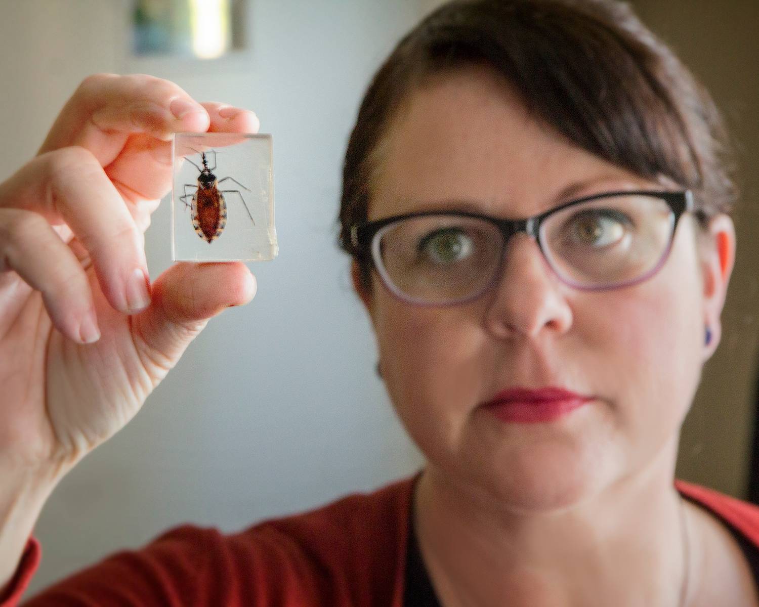 woman holding specimen of bug