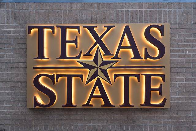 texas state sign on brick wall