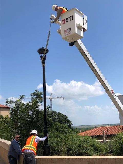 workers installing lamp post