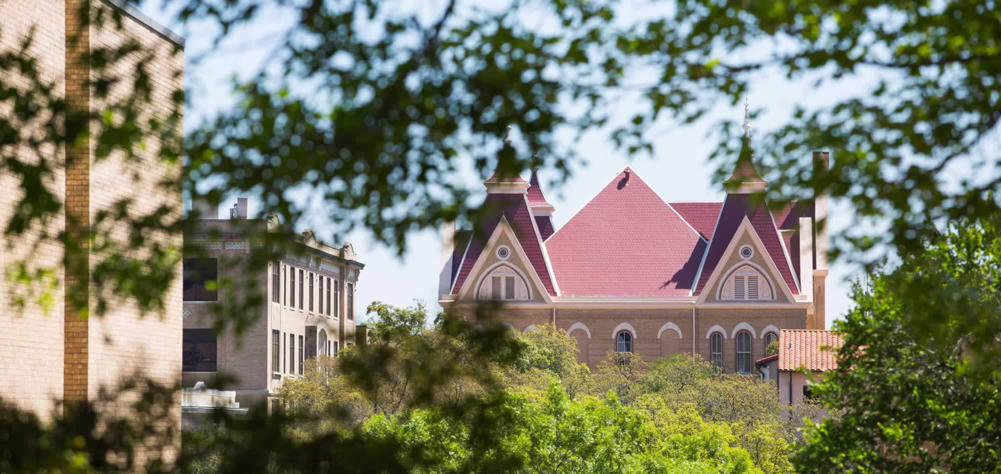 view of old main building through trees