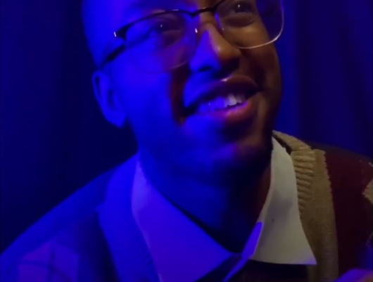man smiling in blue light