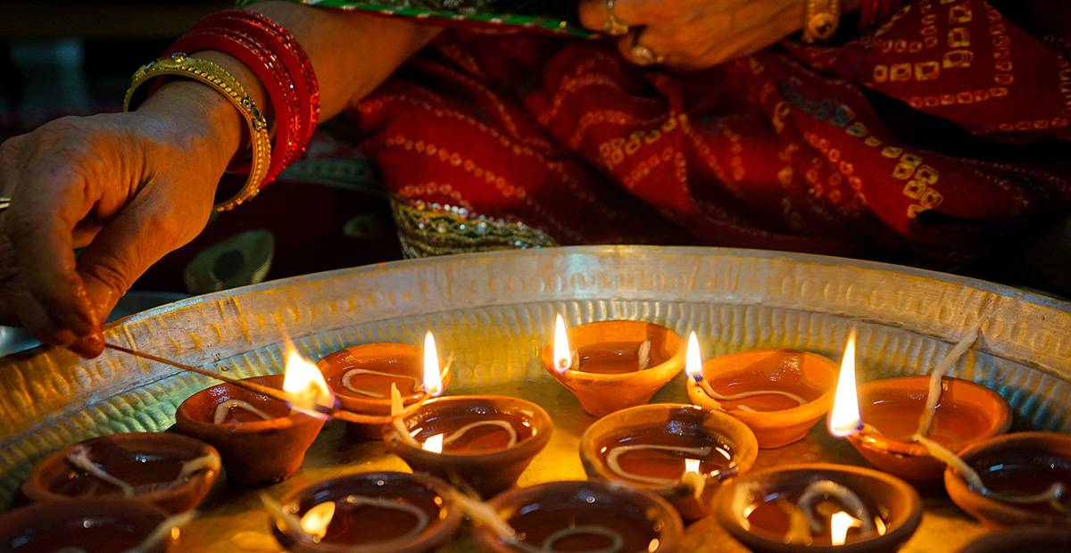 woman lighting wax candles