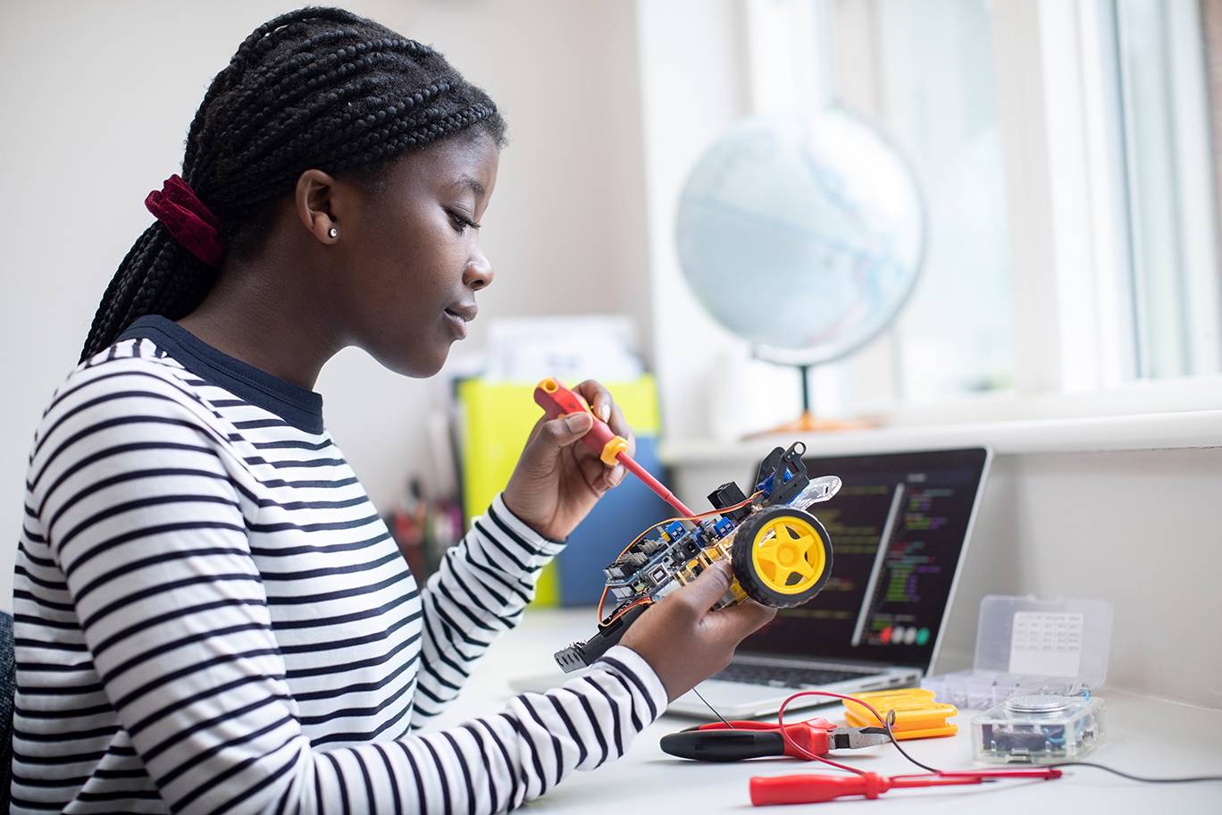 young black lady working on robotic car