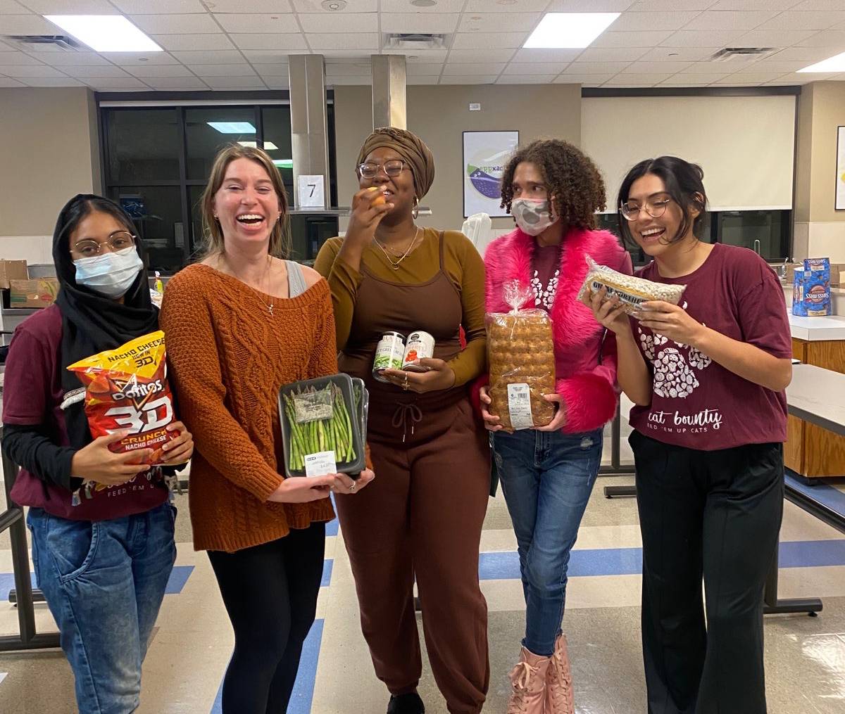 group photo of women holding food