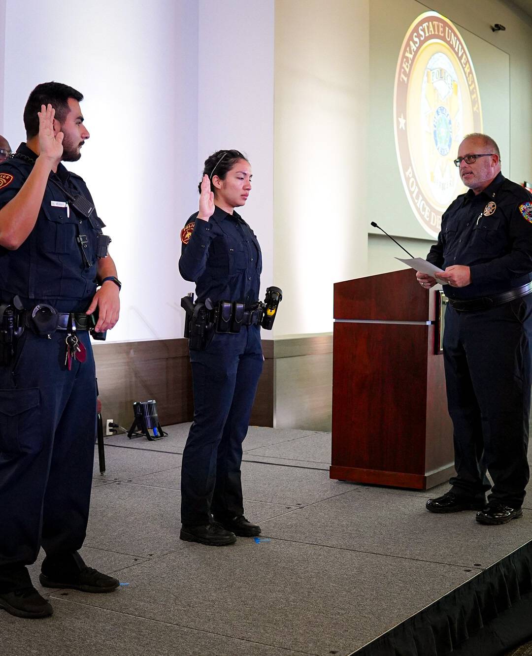 police chief swearing in two police officers