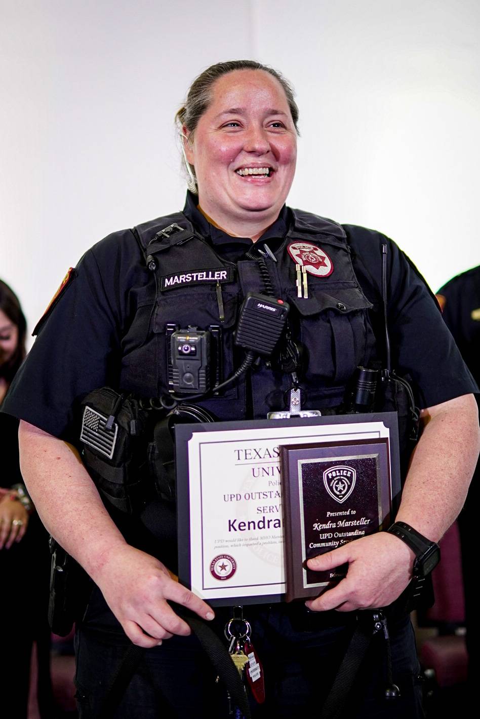 woman smiling and holding award