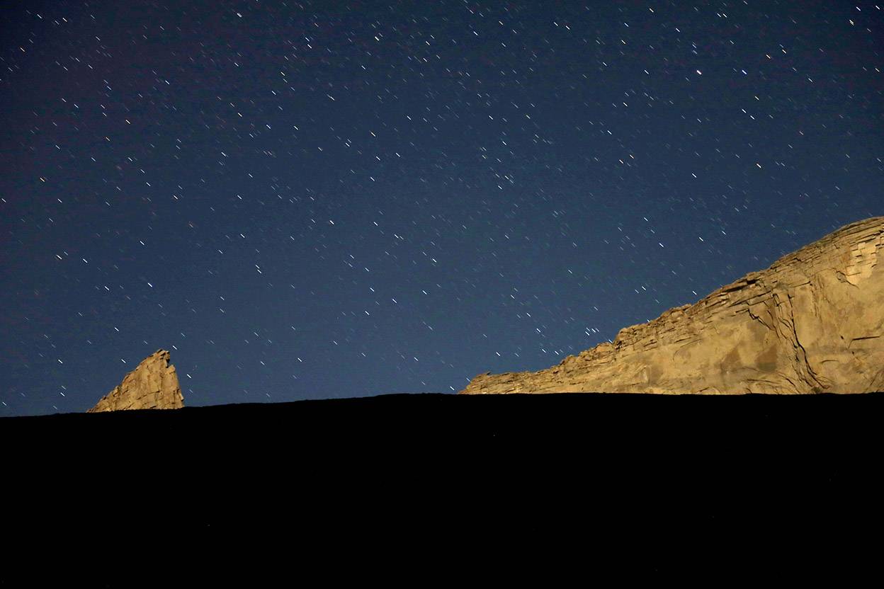 view of stars above mountain ridge