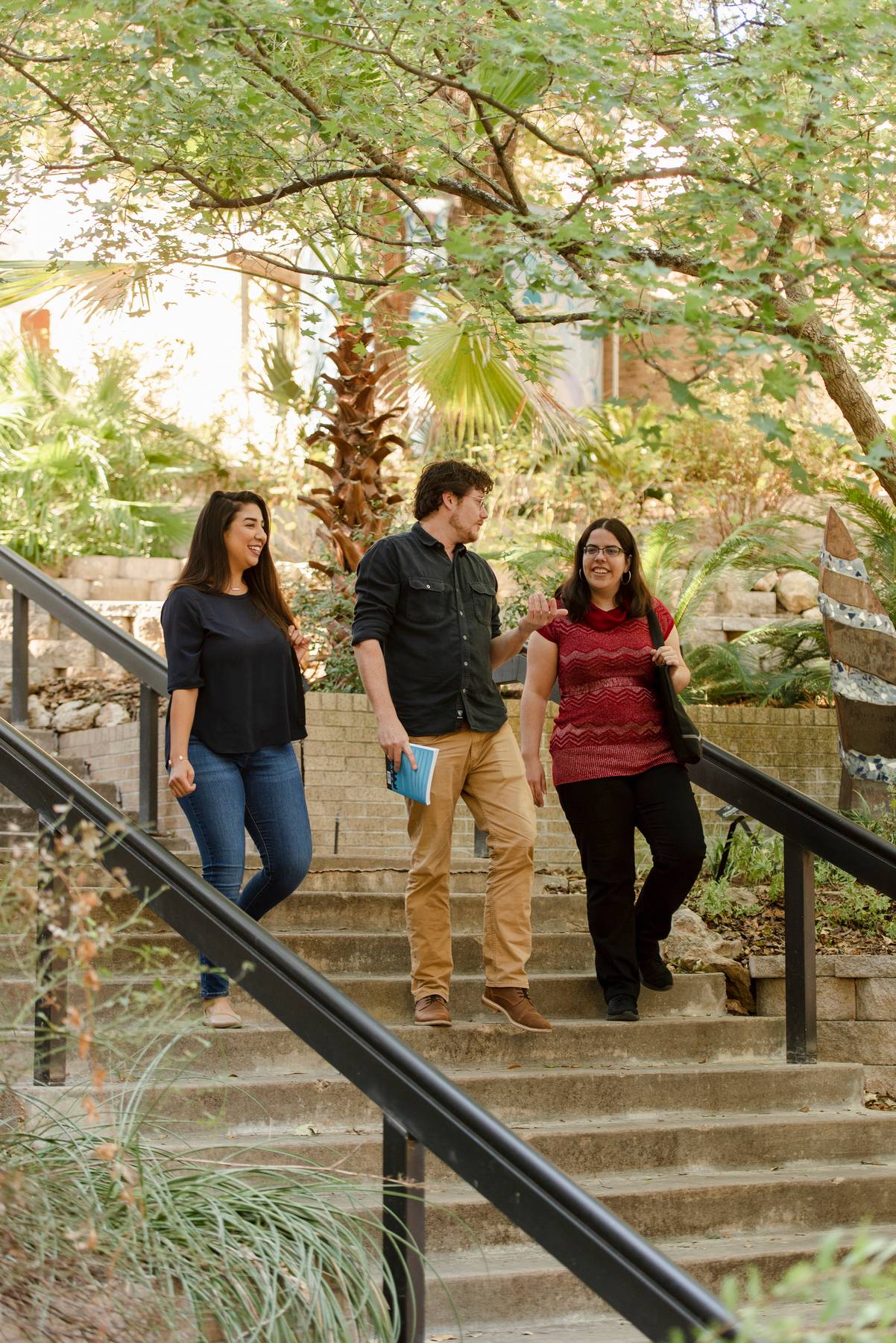 Students Conversing on the stairs outside Centennial Hall. 