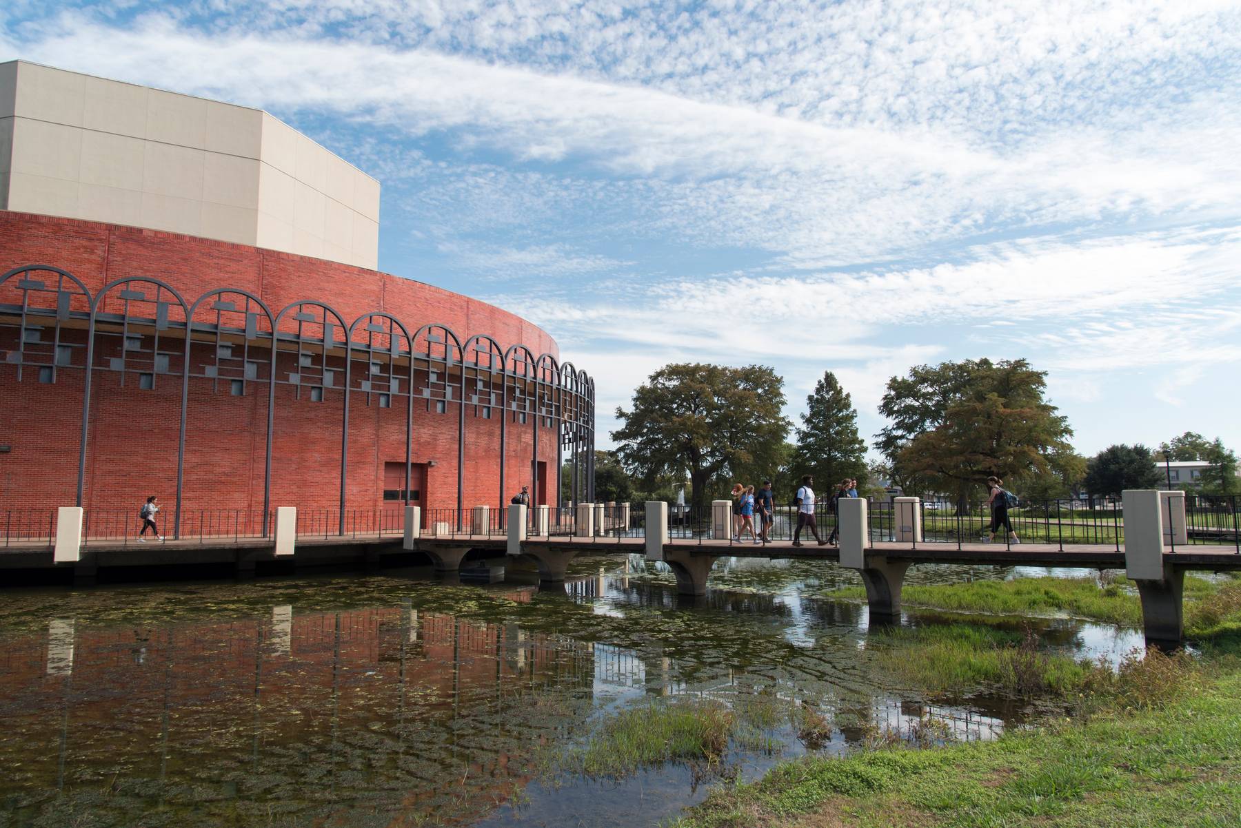 Exterior of the Texas State theater with bridge over a pond.