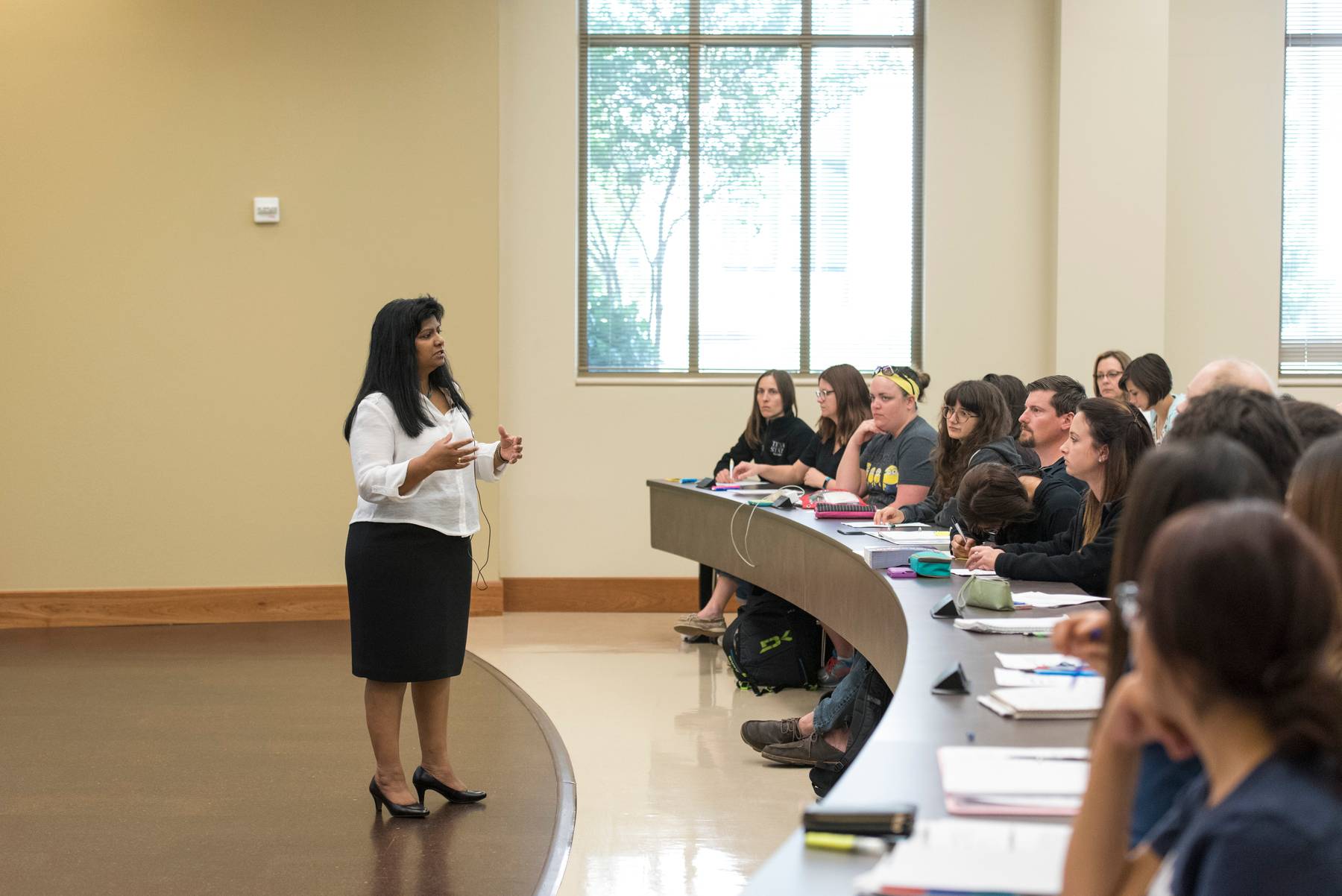 Instructor talking to students in a lecture hall