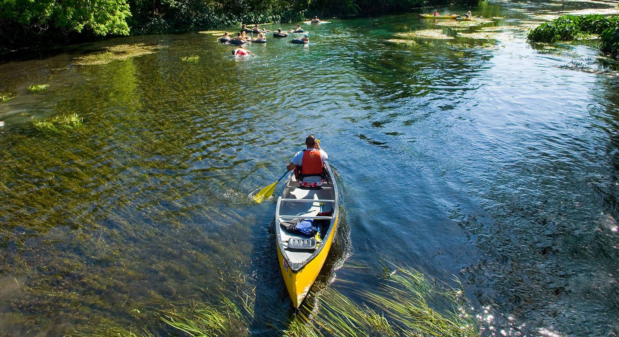 man in canoe on San Marcos River