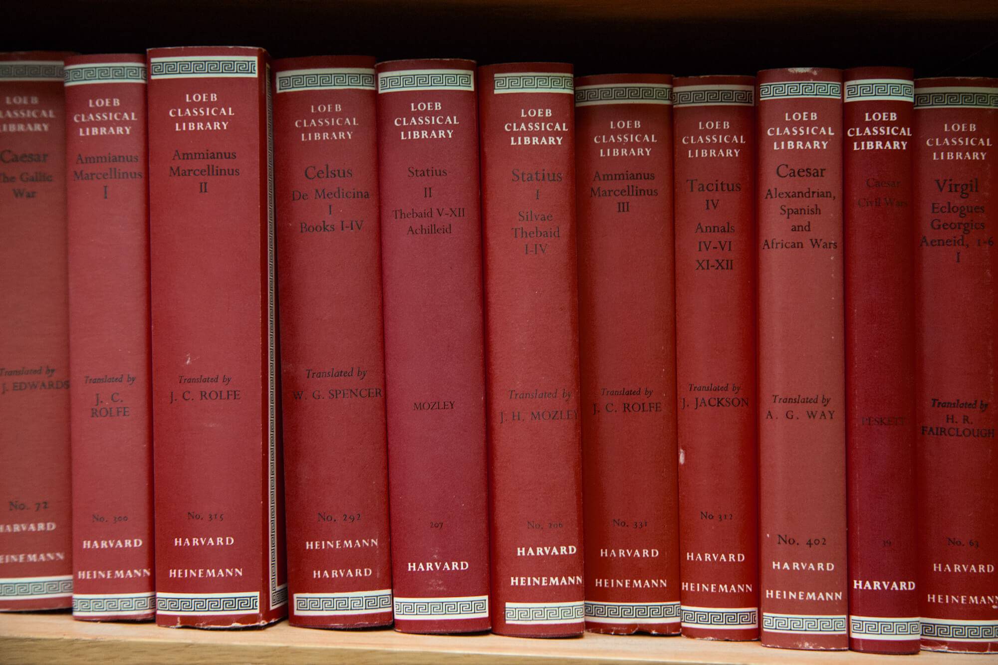 assortment of maroon books