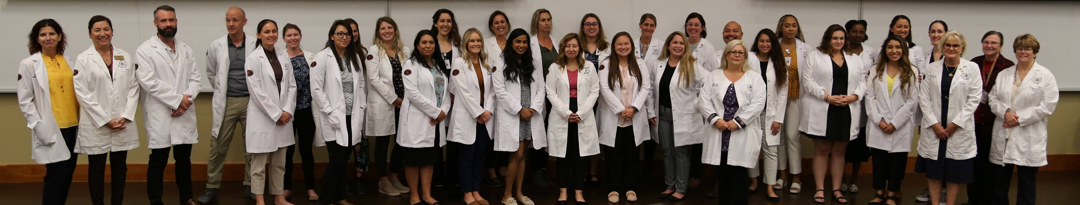 2022 White Coat Ceremony MSN Students and faculty group photo