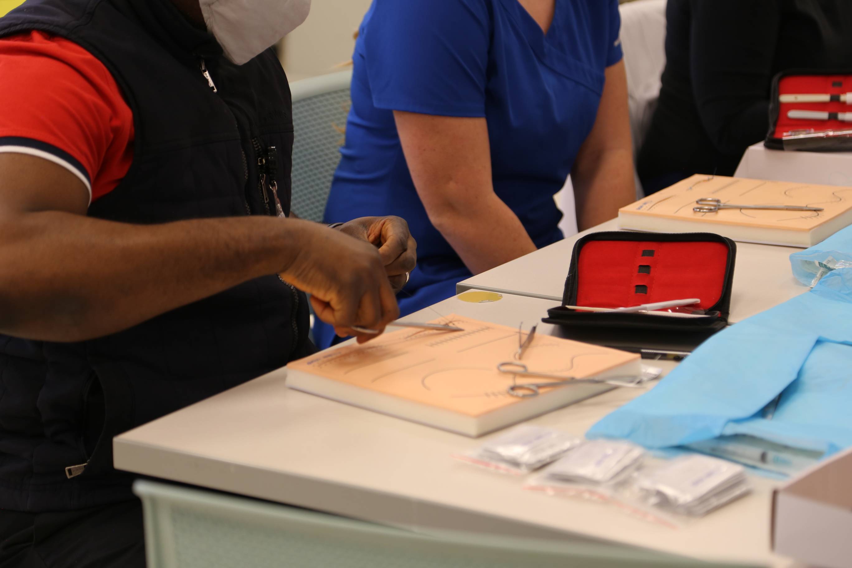 Nursing graduate students practicing suturing in the simulation lab