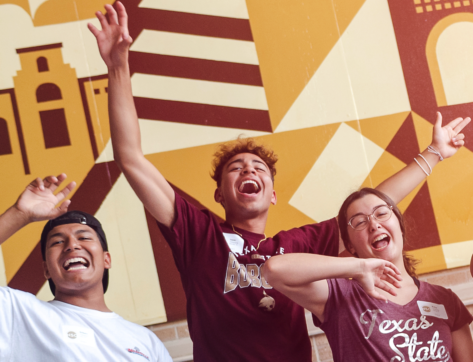 group of students showing school pride and hand signs