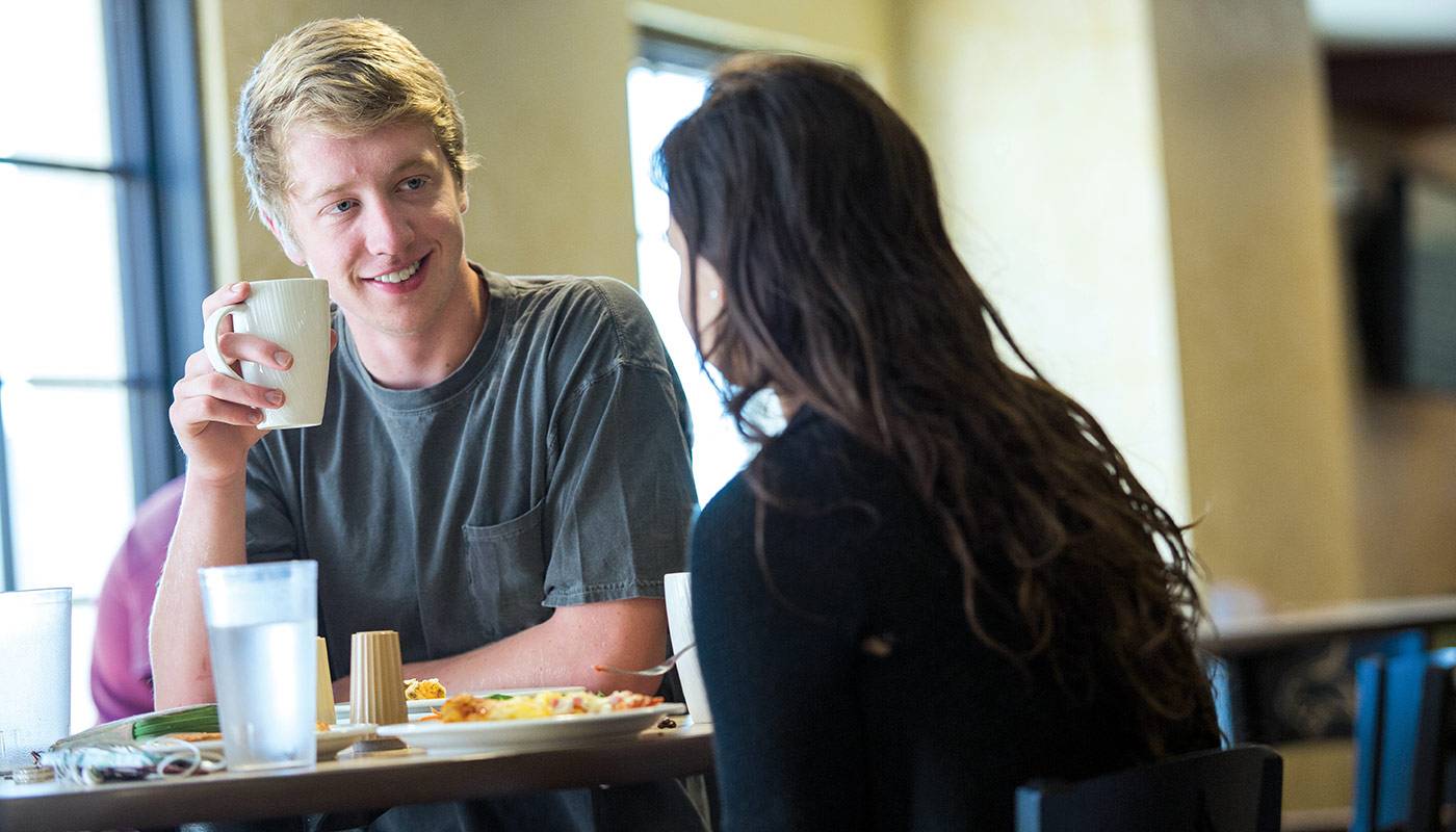 two students eat together in a texas state dining hall