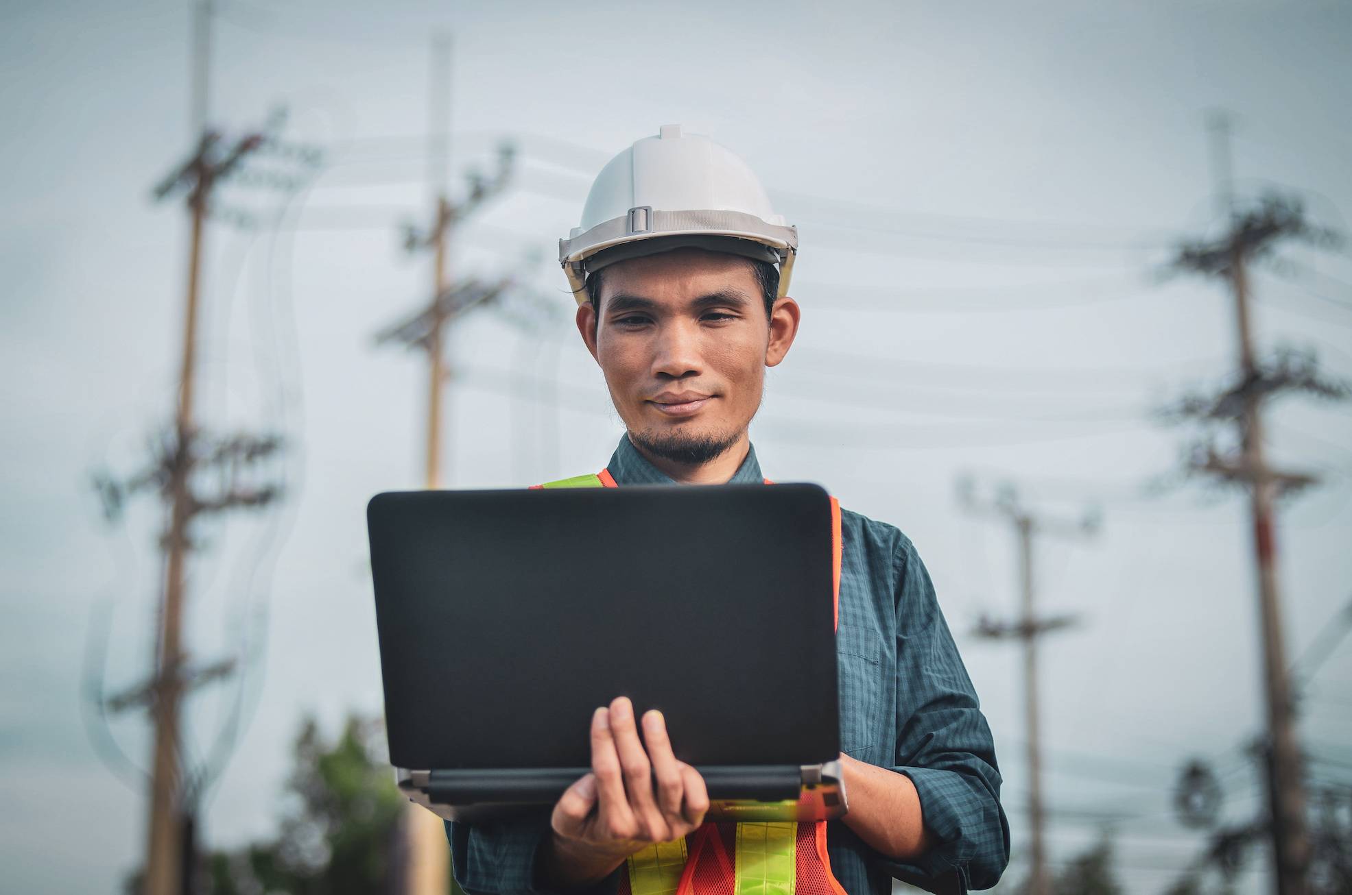 Construction Supervisor holding a laptop