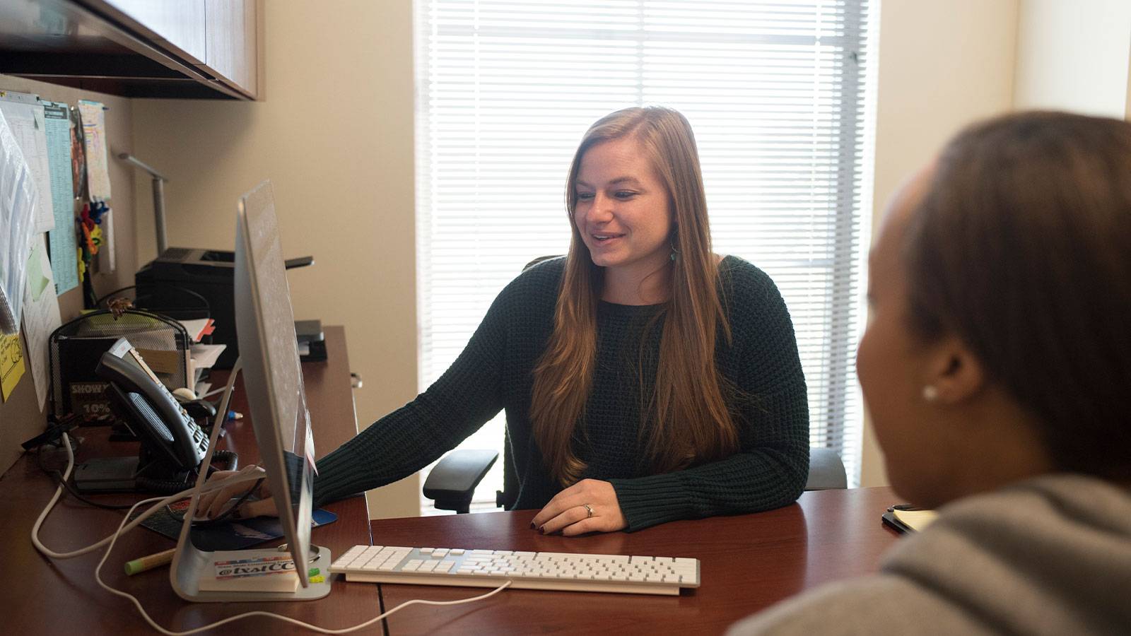 Advisor advising student in their office