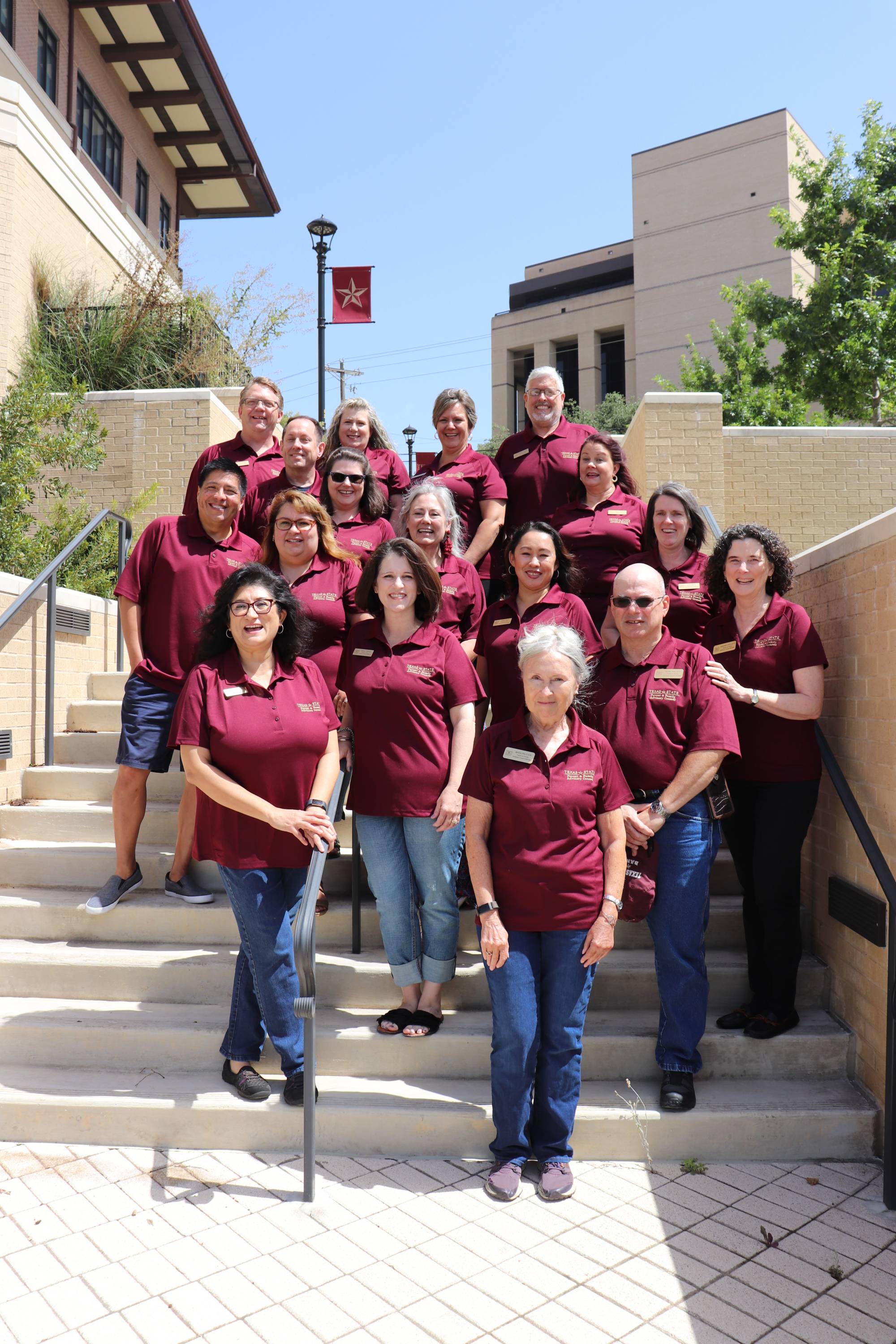 Parent and Family Advisory Council posing for an outdoor photo on stairs