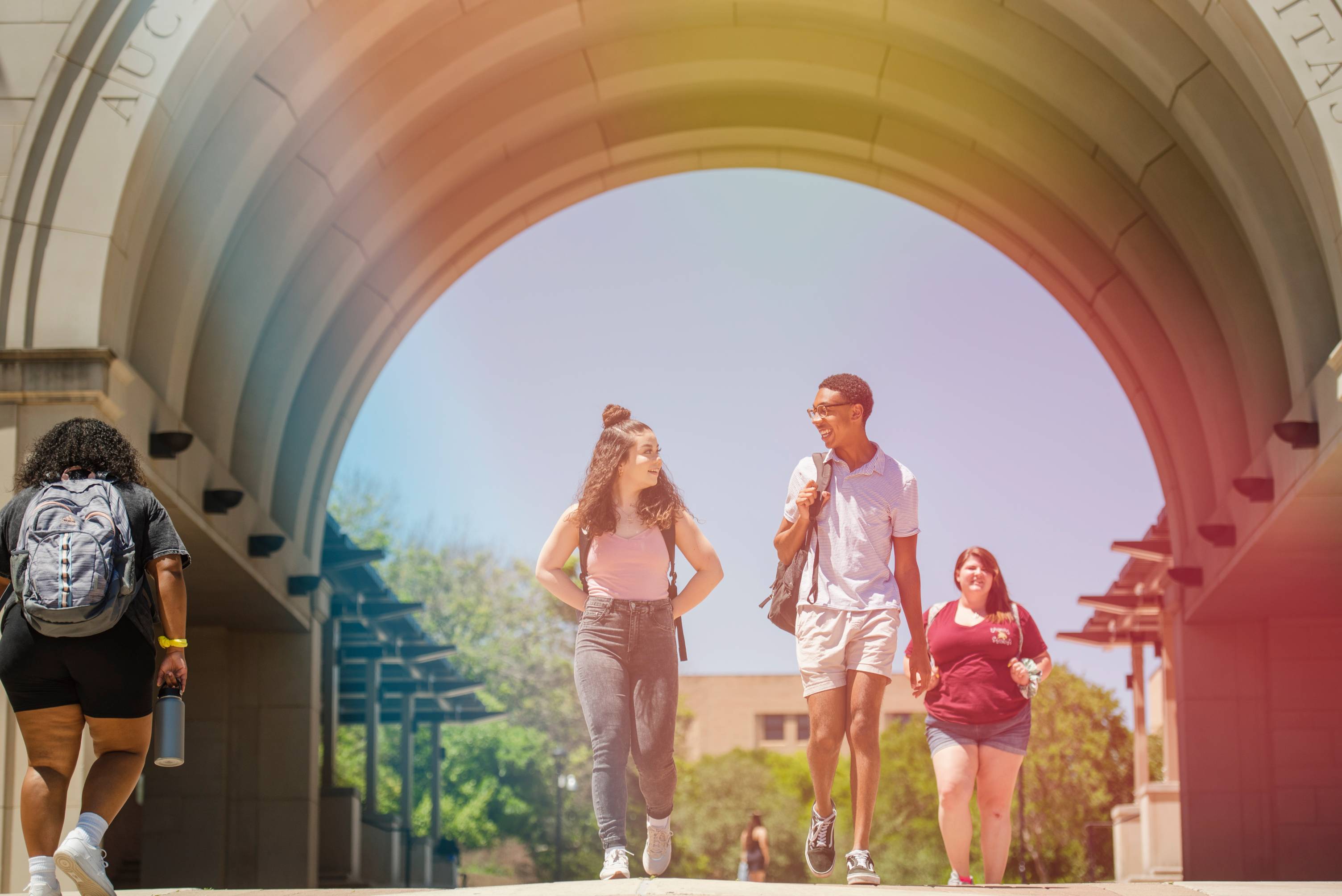 Students under UAC arch walking