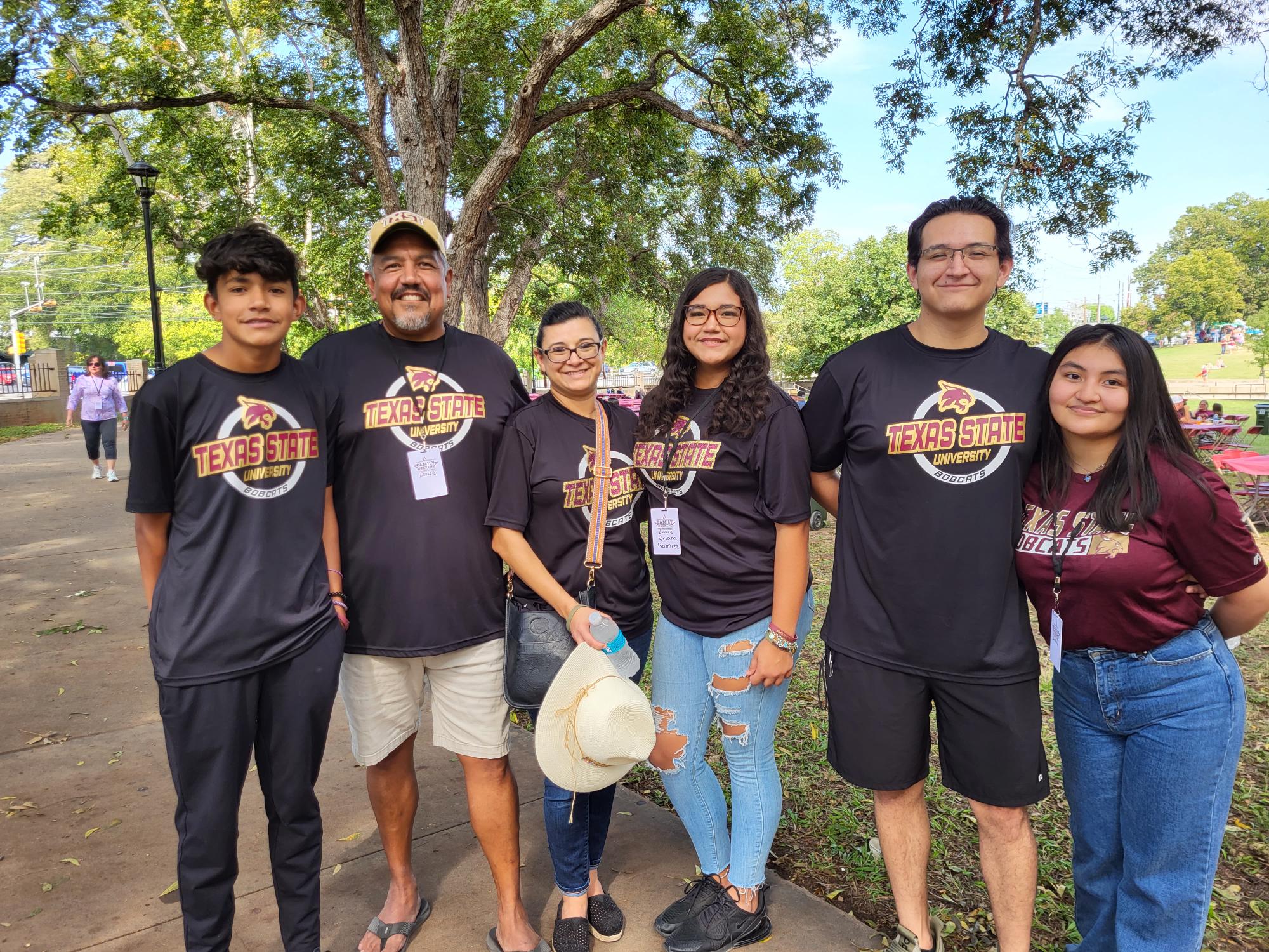 Student standing next to family members