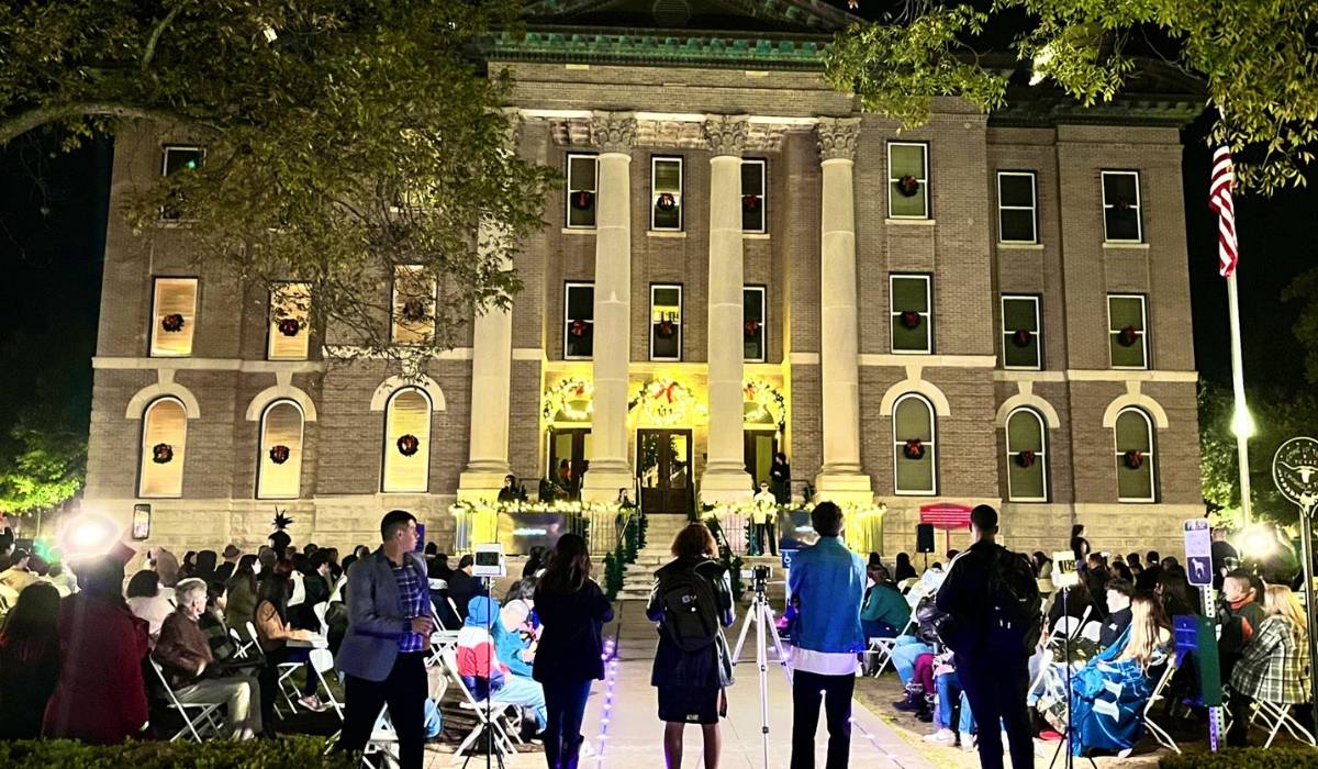 People standing in front of the old courthouse in San Marcos for the TXST Fashion show
