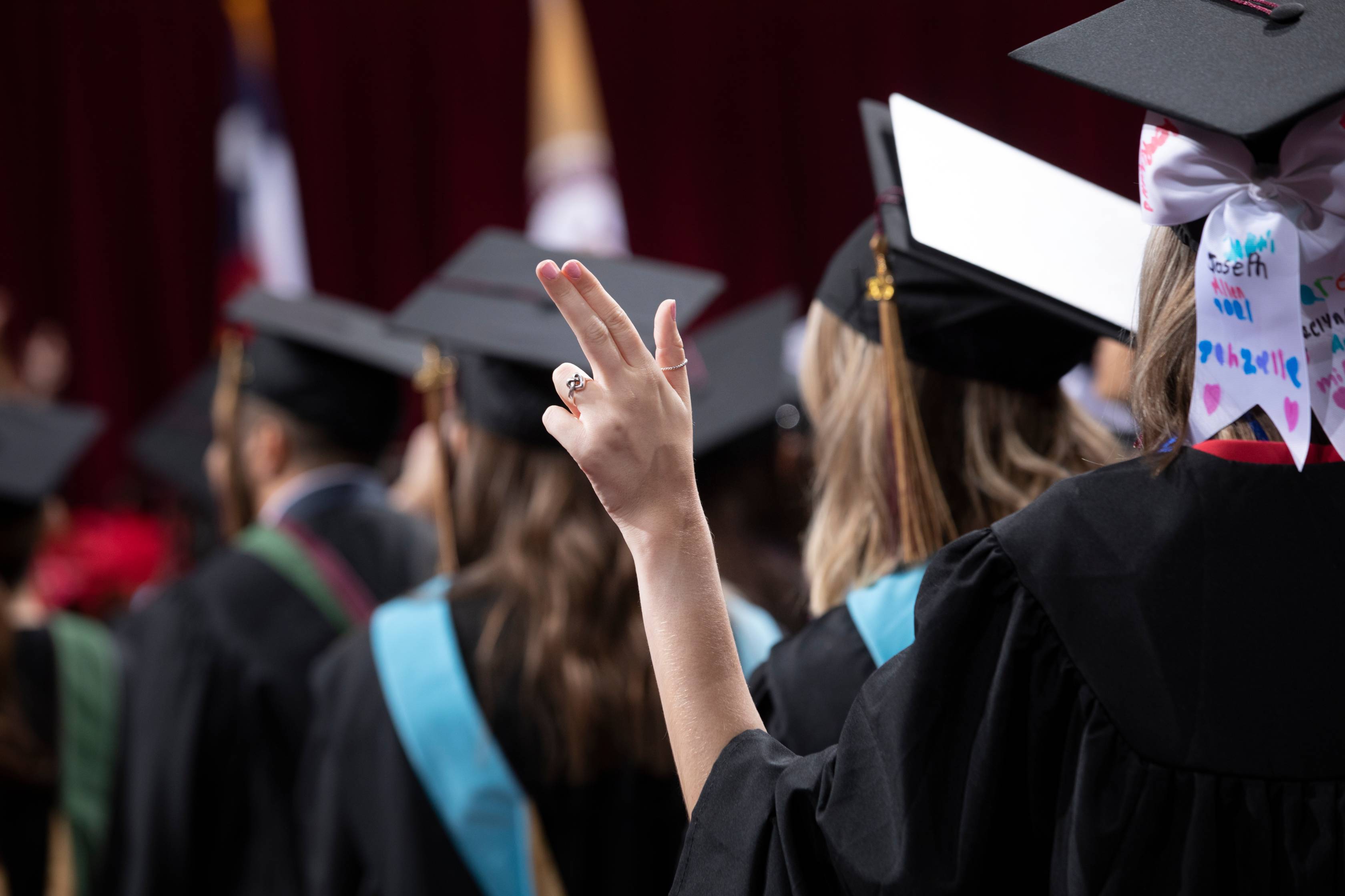 Heart of Texas hand sign at graduation