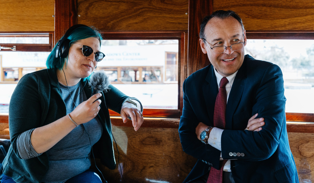 President Damphousse smiling with interviewer on glass bottom boats
