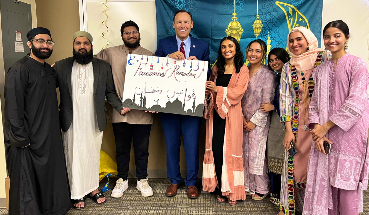 President Damphousse holding a sign that says Fawanis Ramadan with students