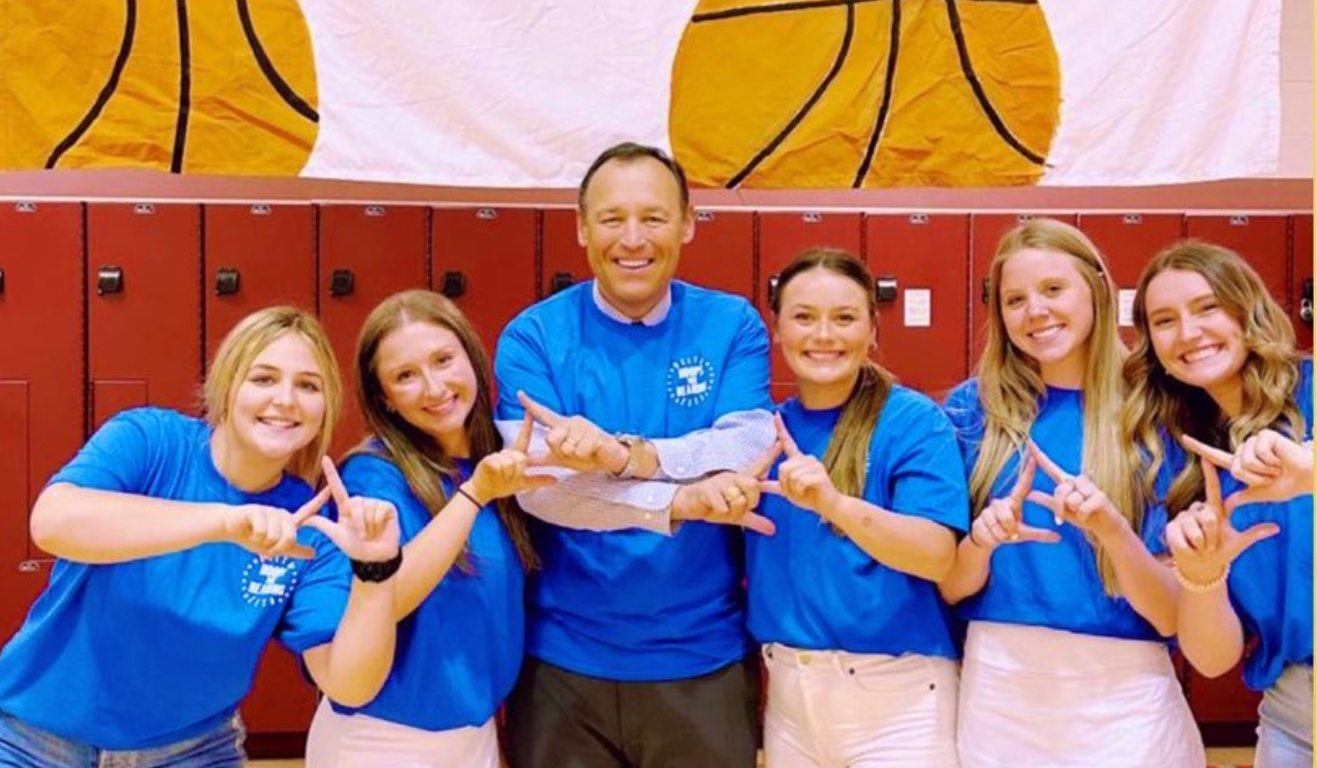 President Damphousse smiling with sorority students