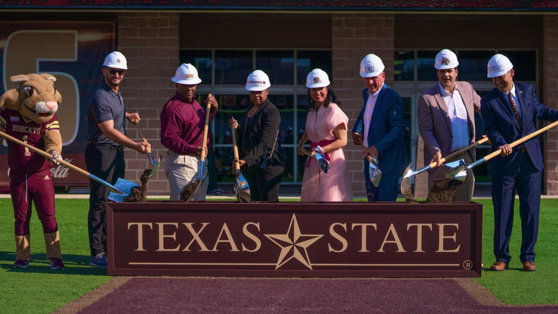 President Damphousse, Boko, and other TXST community members participate in a groundbreaking ceremony while holding shovels.