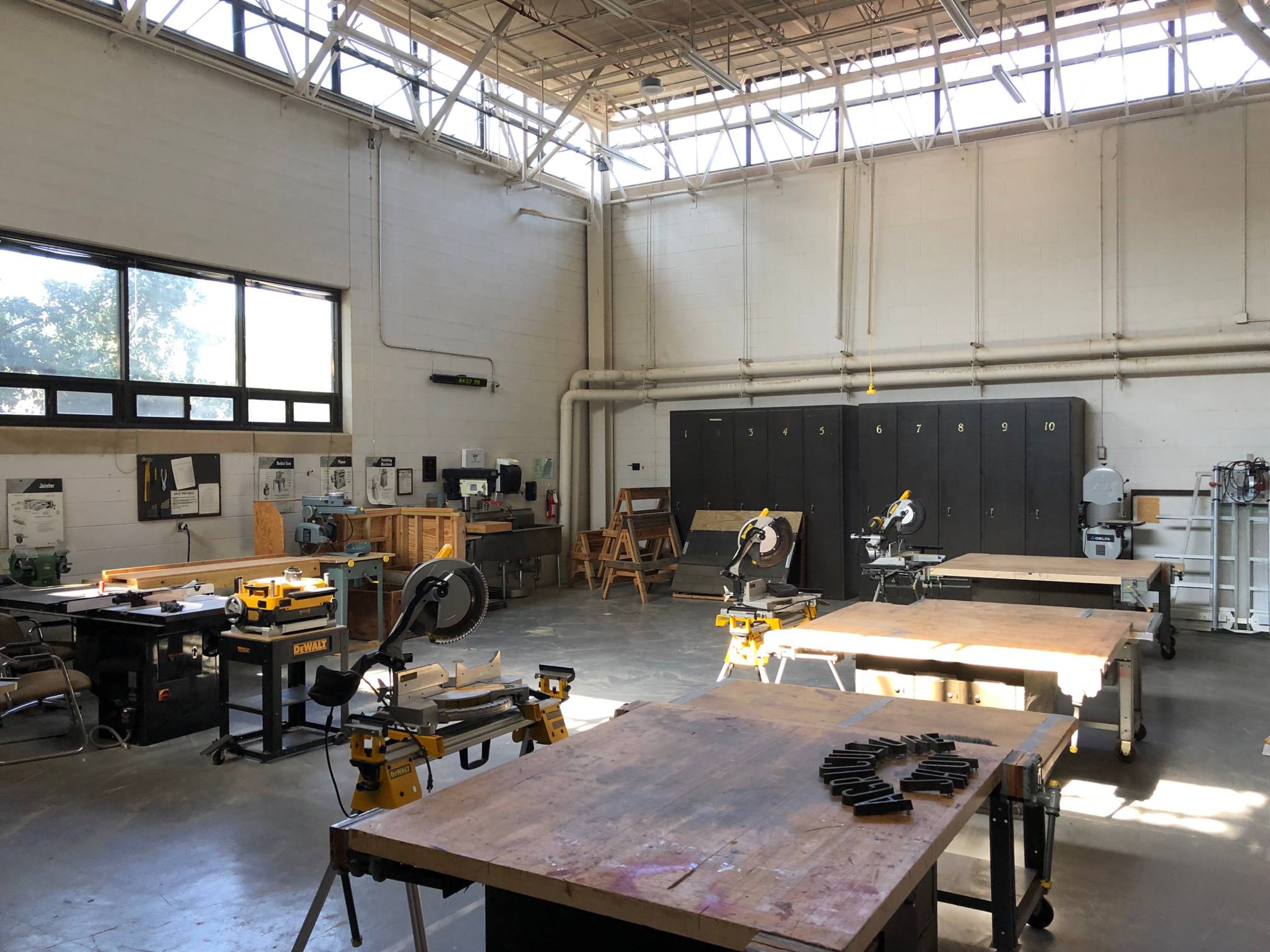 Large room with power tools, tables, and construction equipment