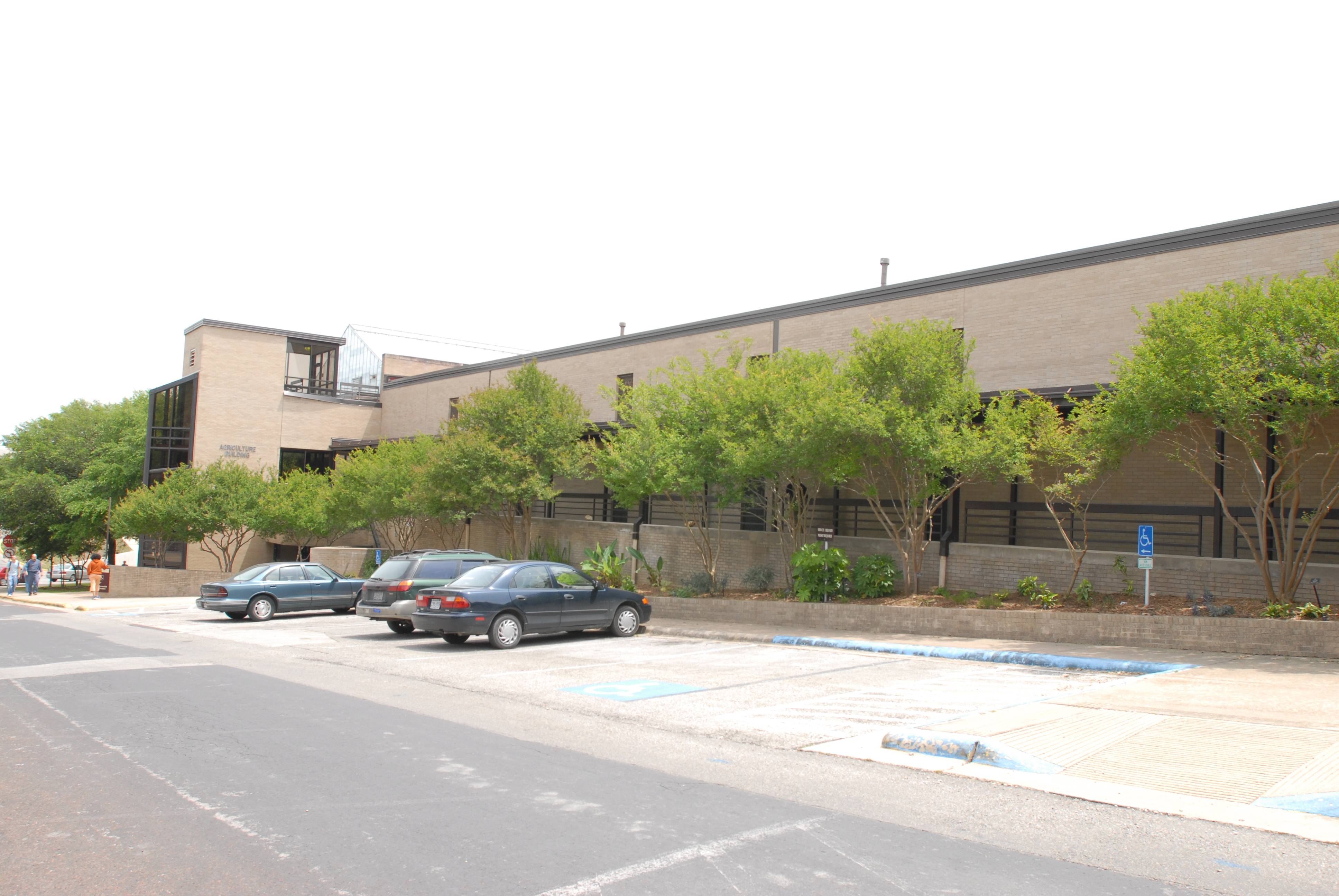 building with trees and cars out front