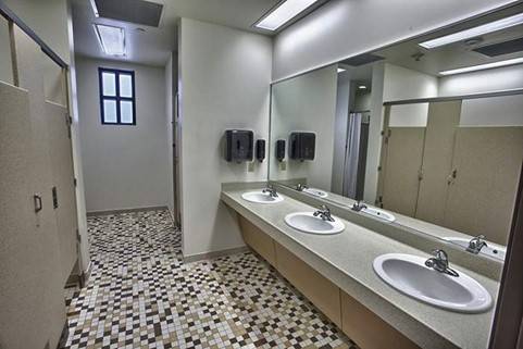 Bathroom with two sinks and stalls