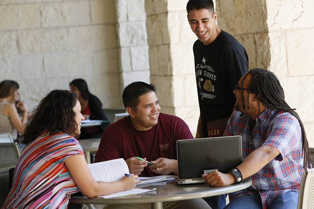 students sitting in a group doing homework