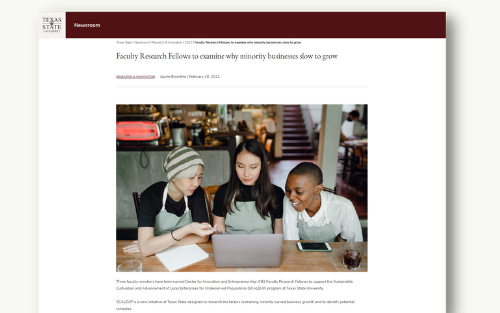 Beginning of university news release with a photo of three individuals looking at a laptop