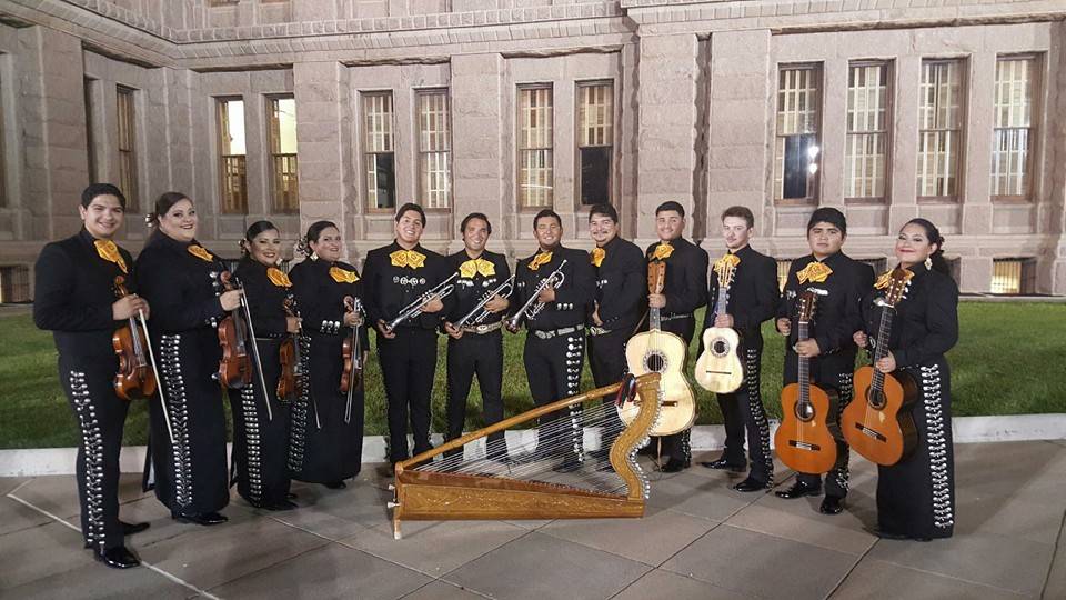 Mariachi Nueva Generacion ensemble standing outside the performing arts center.