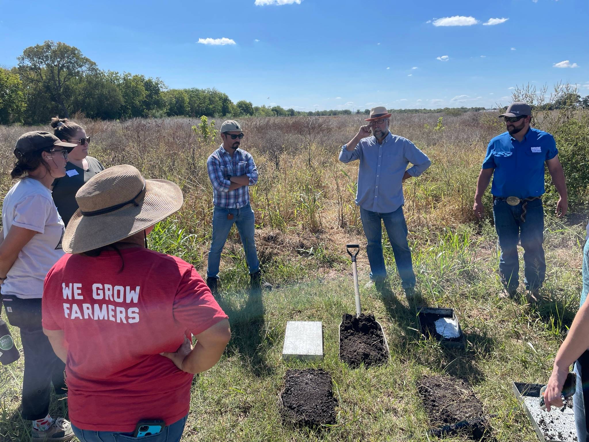 Dr. Ken Mix and workshop attendees discussing soil samples