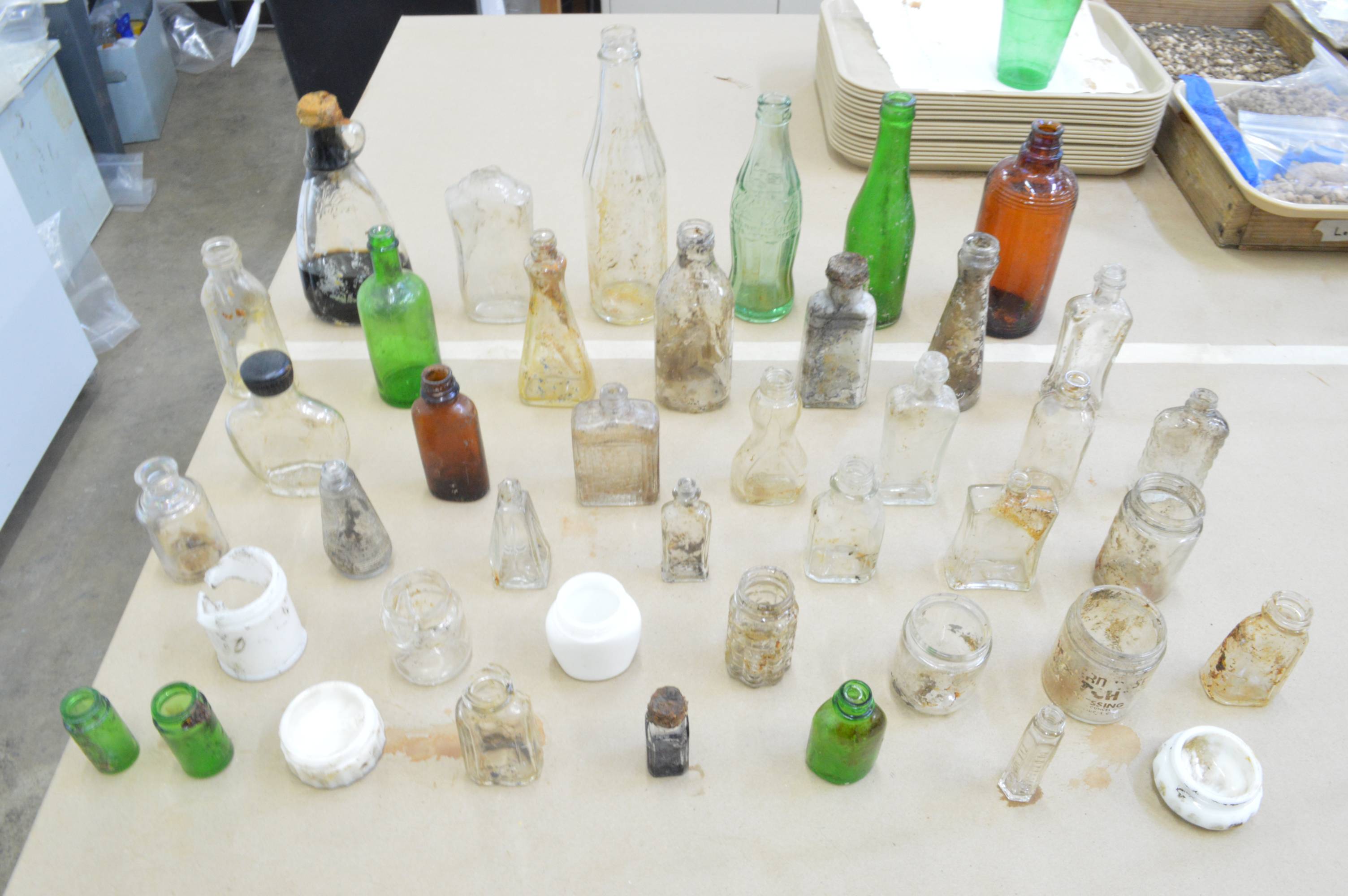 collection of bottles and jars from a mid-century midden site