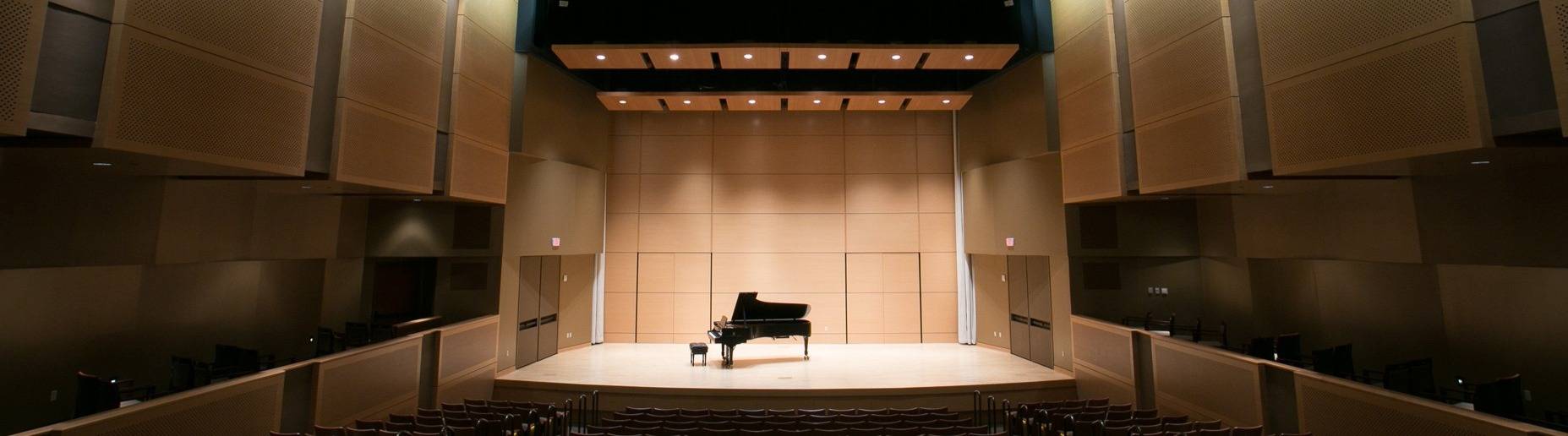 recital hall with a grand piano in the center