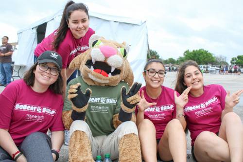 Bobcats pose for a photo during Bobcat Build event