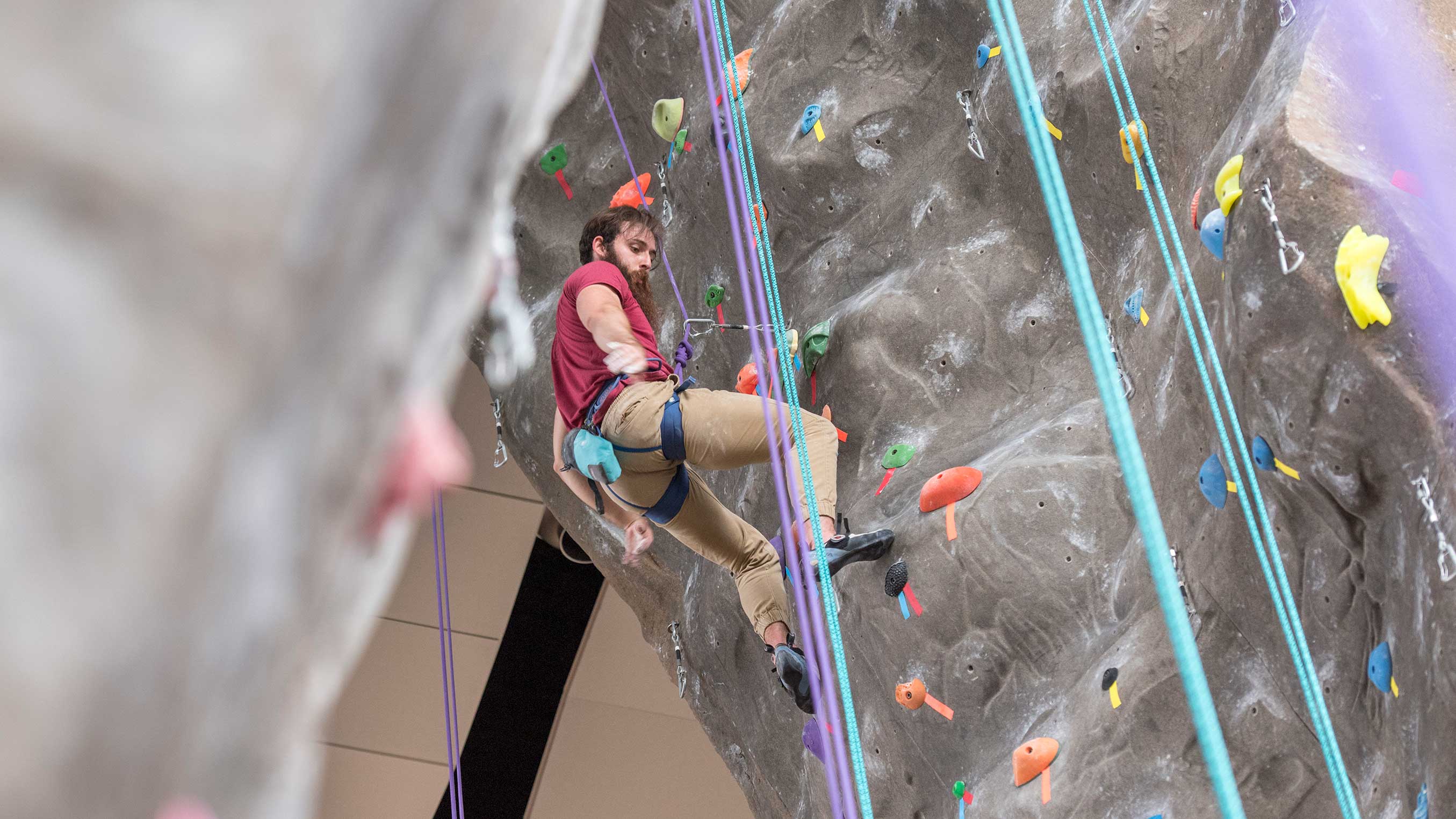 a student rock climbs at the rec