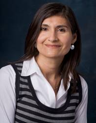 Professional Photograph of Elsa Thorn. She is smiling and wearing a stripped shirt.